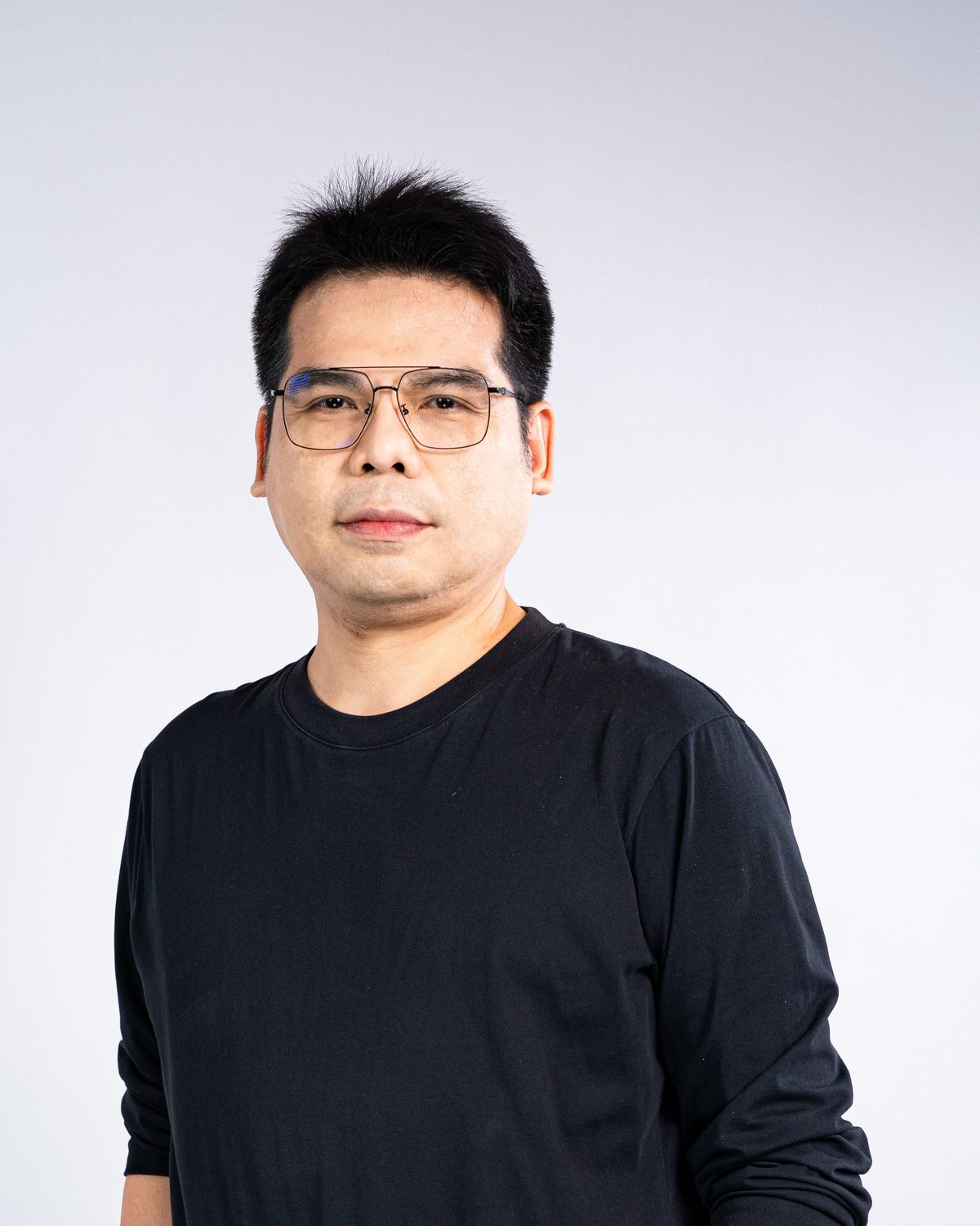 Ravi Anyakarn, founder of FengshuiX, half-length portrait in a black shirt